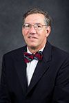 Man wearing glasses and a bow tie.