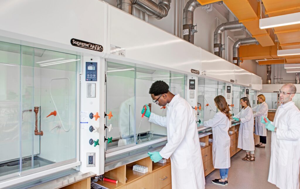 Students working in fume hoods.