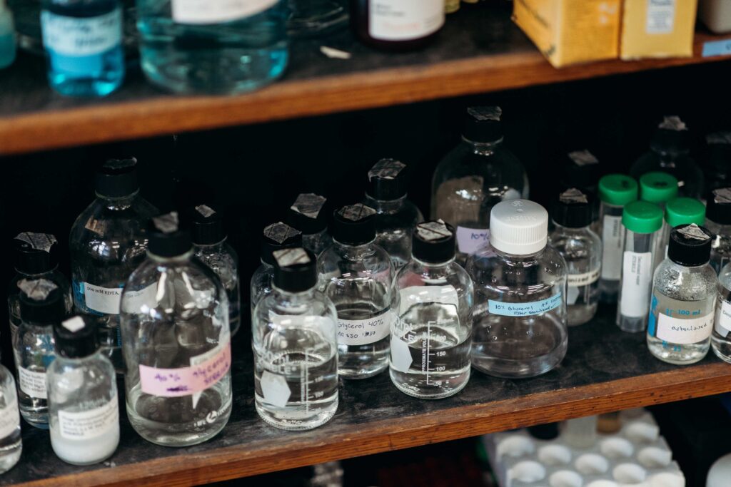 Shelf full of bottles labeled with various chemicals.