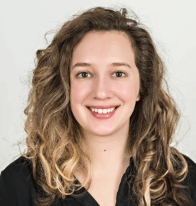Woman with curly light brown hair.