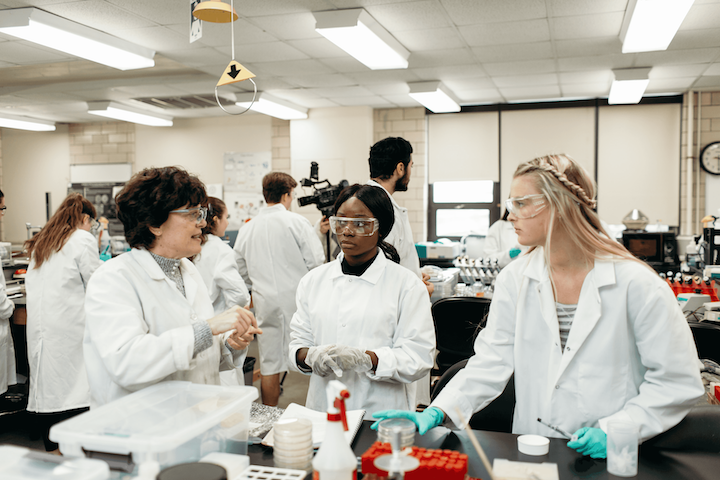 Dr. Cornely in a lab with two students.