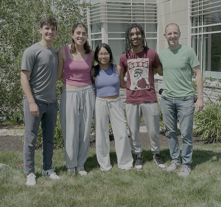 Five people standing outside.
