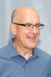 Man wearing glasses and a blue shirt.