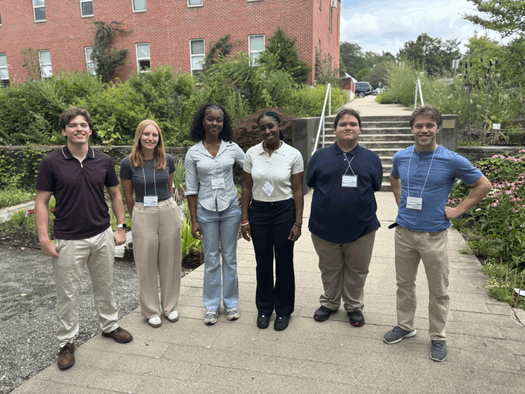 Six students standing in a semicircle.