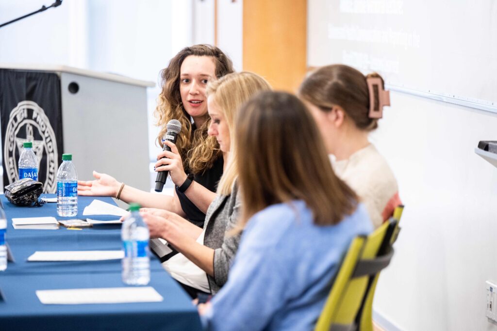 Alumni at a table in discussion.