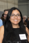 Woman with long dark hair and glasses.