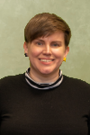 Woman with short brown hair wearing a black sweater.